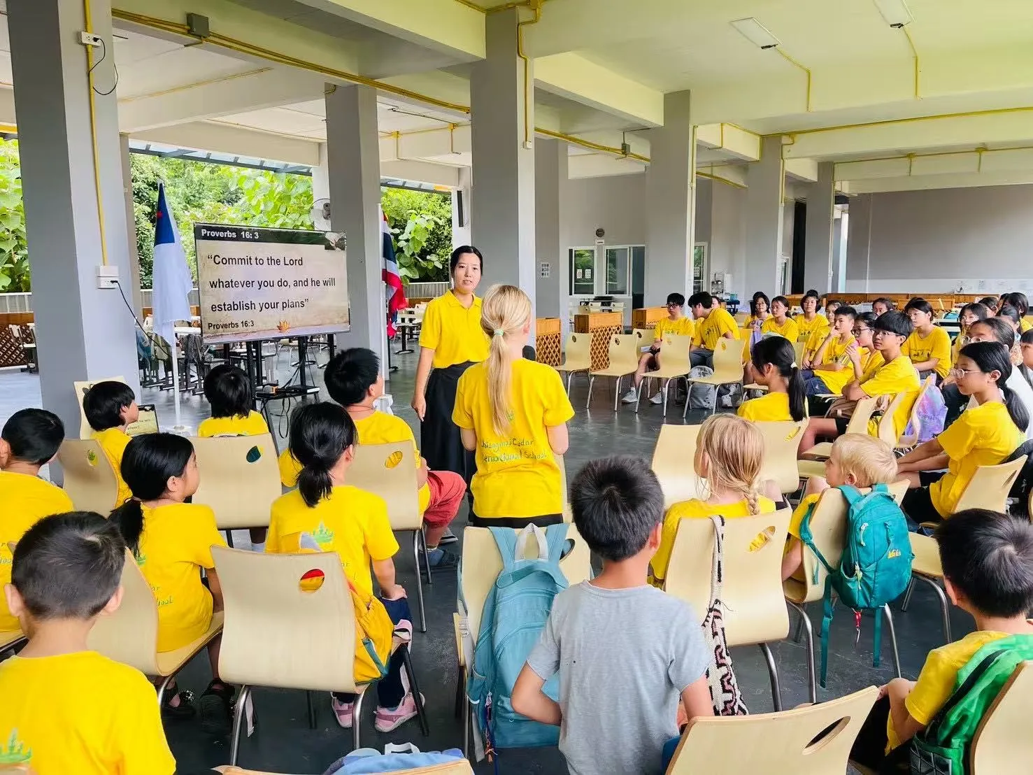 Students and a teacher leading morning devotion together